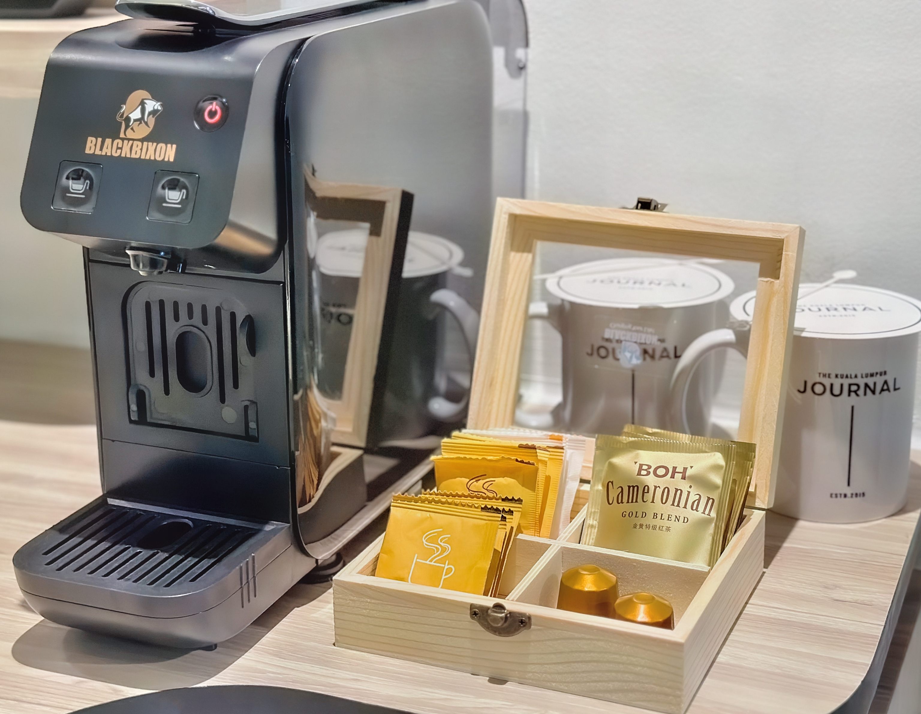 Black coffee machine and white tea cups In-Room Expresso Machine at KL Journal Hotel